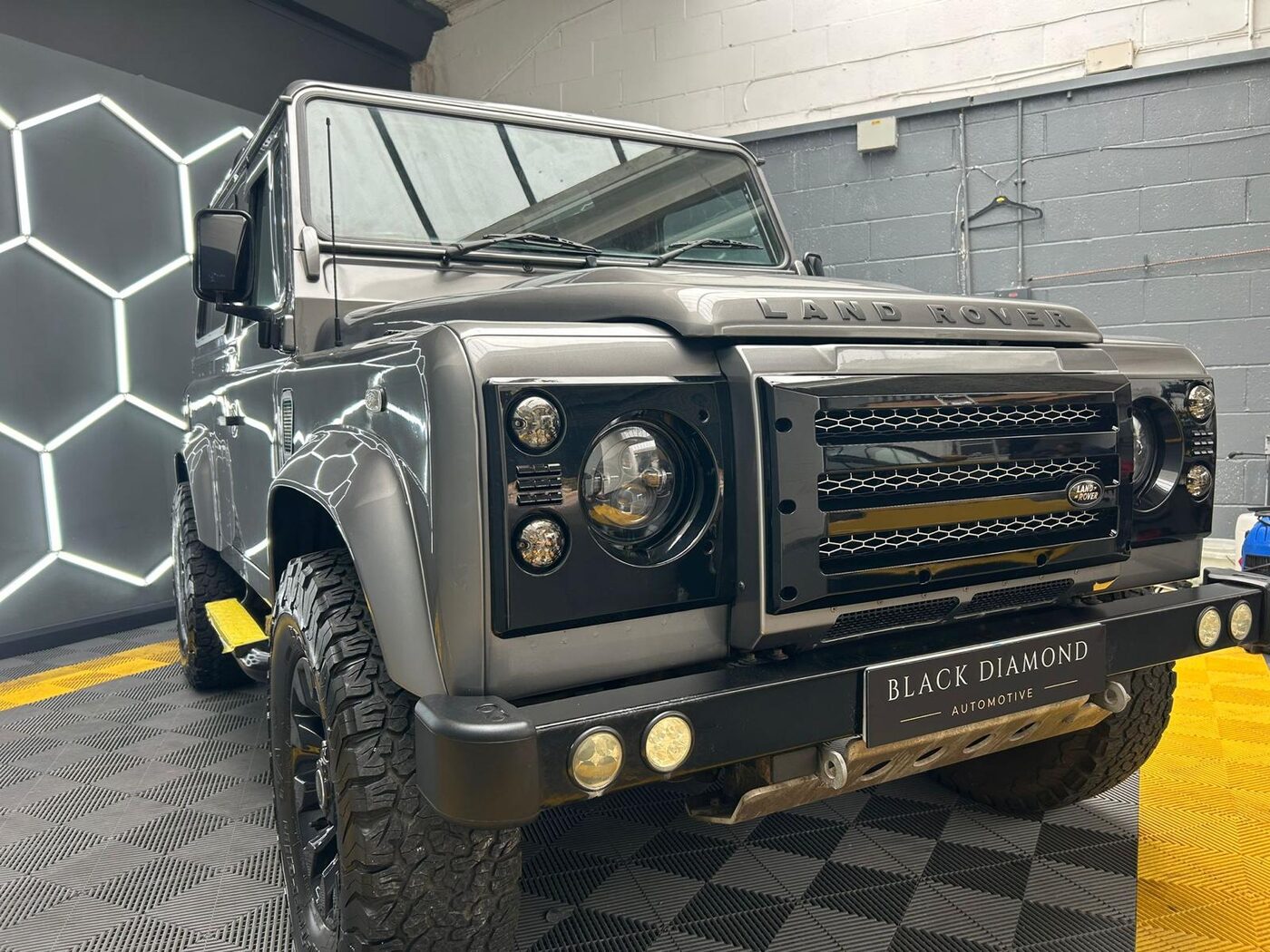 Land Rover Defender front grille, workshop backdrop